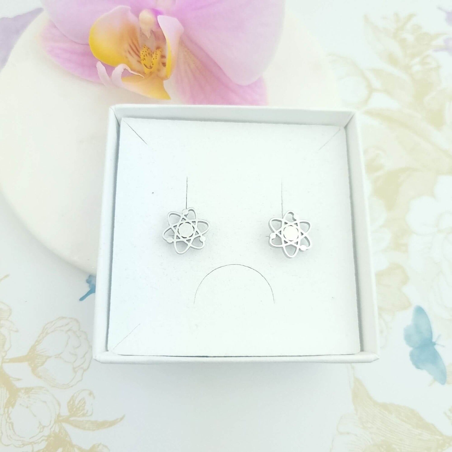 atom stud earrings in a gift box