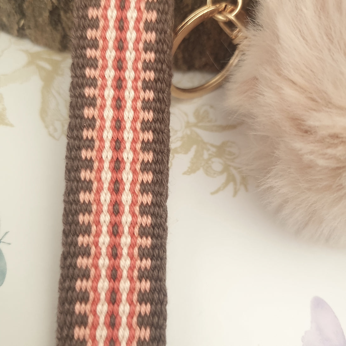 wristlet strap keychain with pom pom in terracotta tone