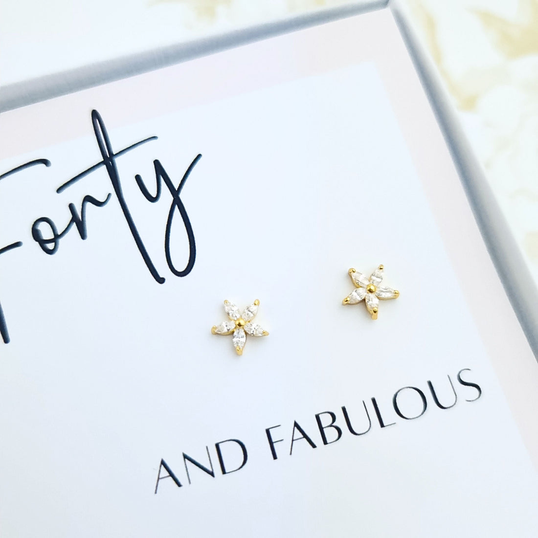 40th birthday gift with sparkly gold floral stud earrings displayed on Happy Birthday card in gift box