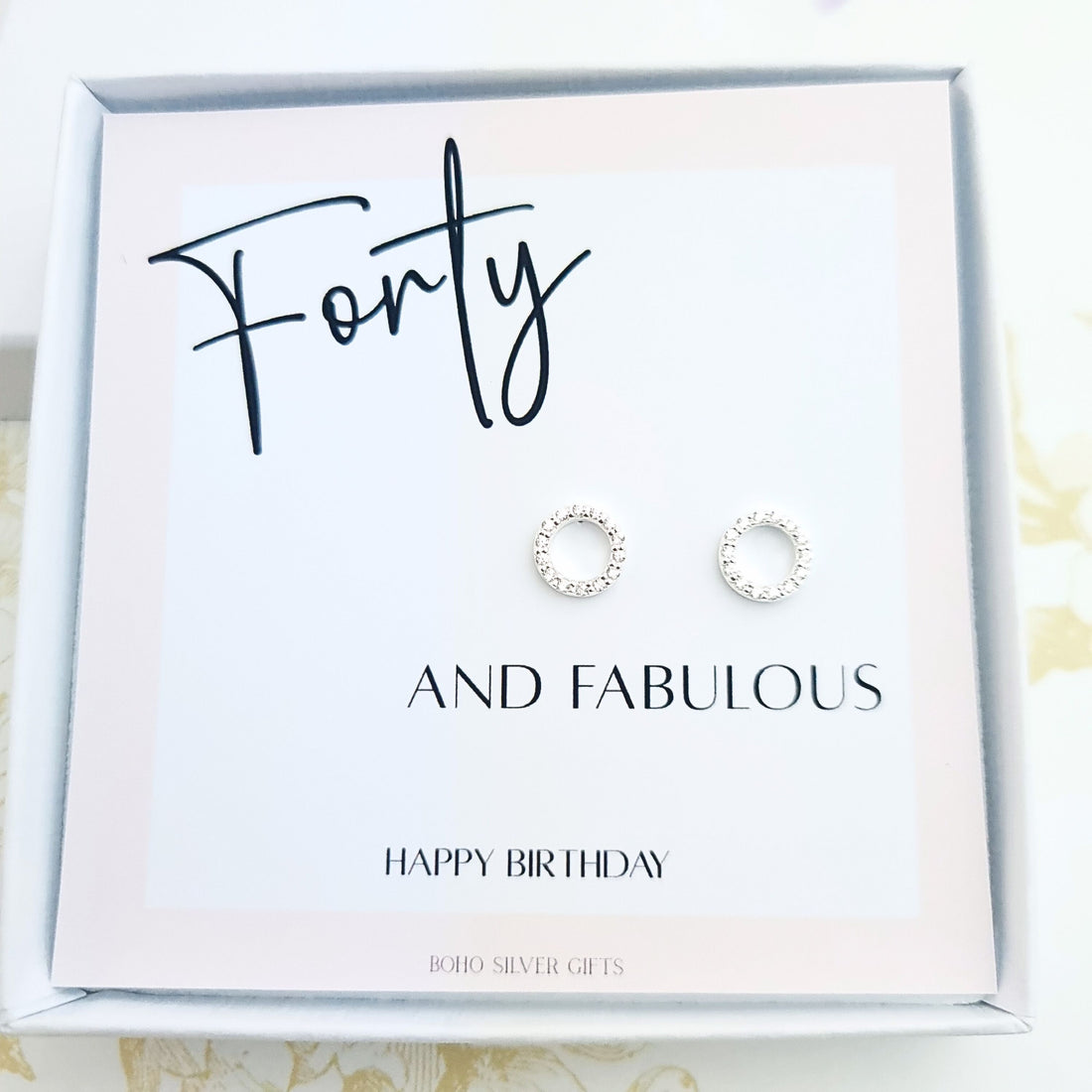 Sterling silver circle stud earrings displayed on a birthday card with the message "Forty and Fabulous – Happy Birthday"