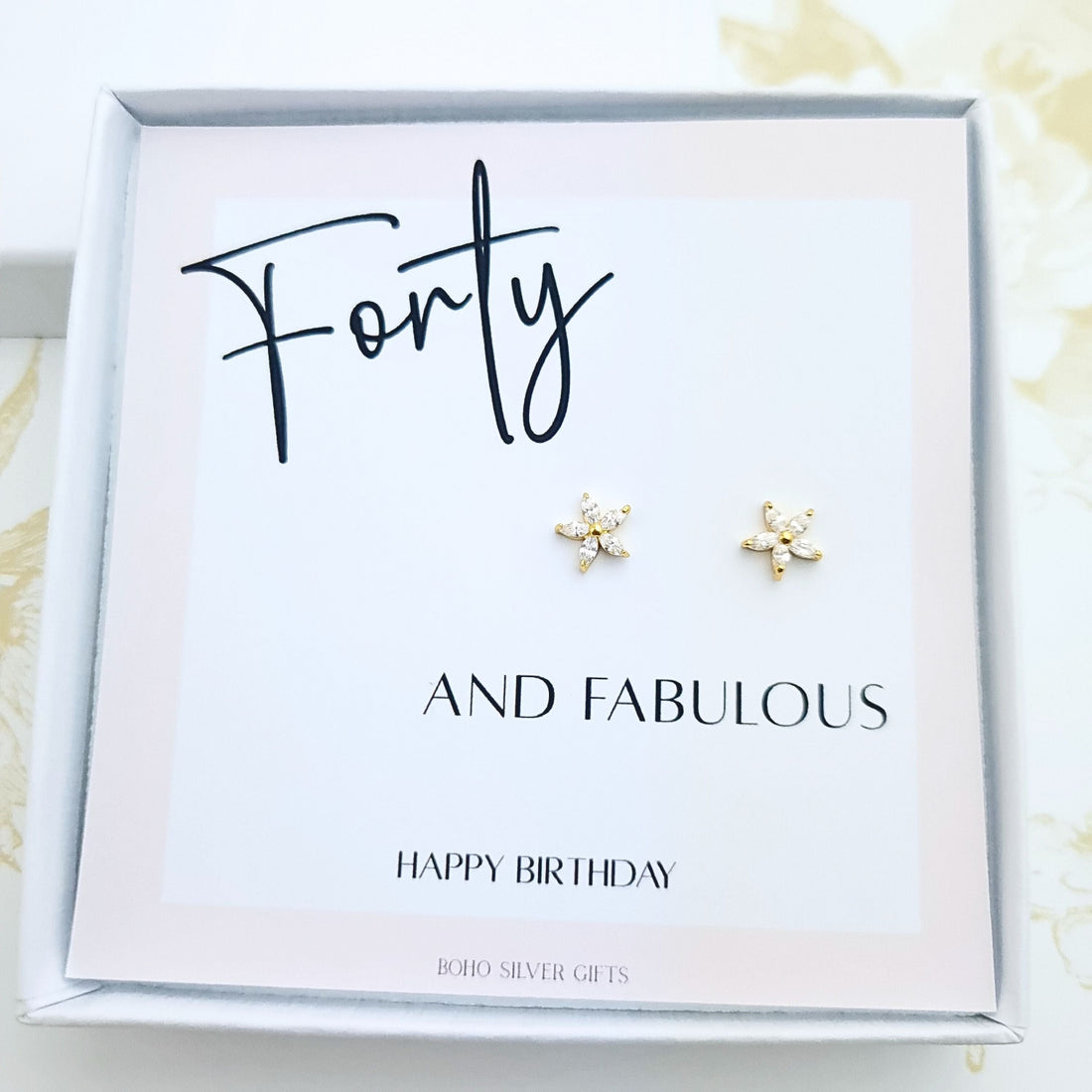 40th birthday gift with sparkly gold floral stud earrings displayed on Happy Birthday card in gift box