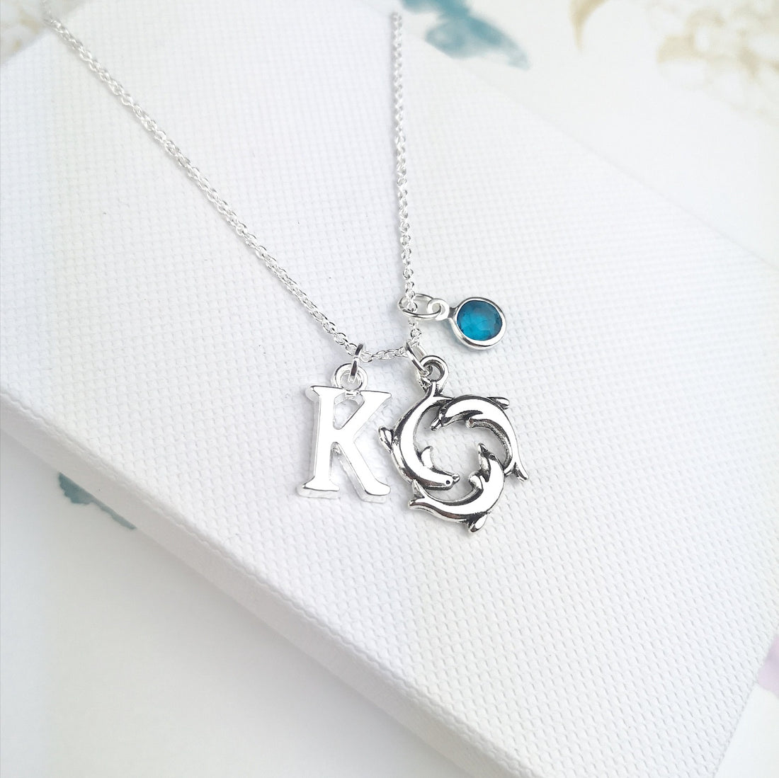 Dolphin sterling silver necklace with initial and birthstone in a gift box