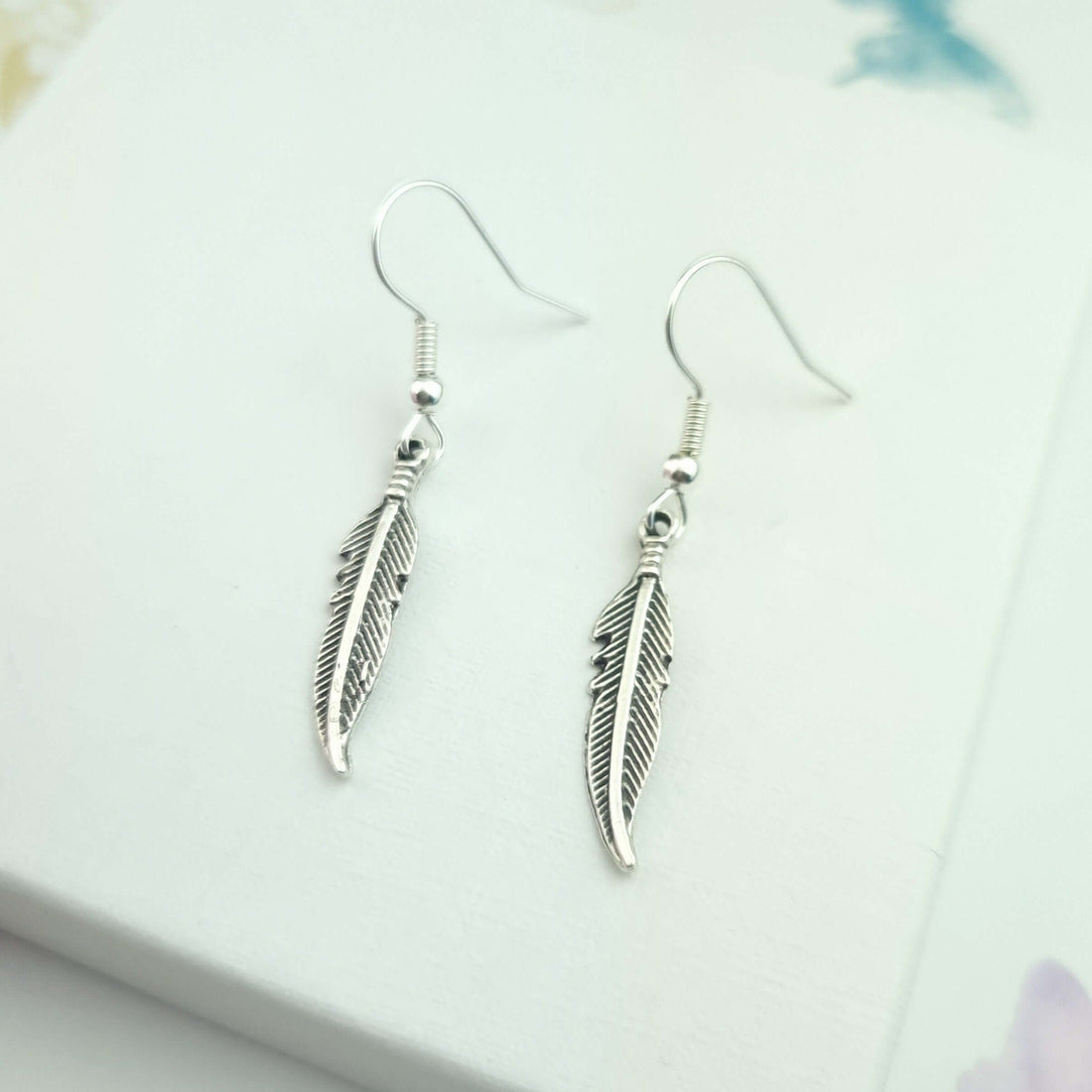feather dangle drop silver earrings