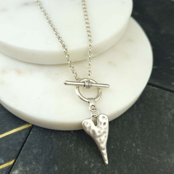 chain link necklace with toggle clasp and a hammered heart as pendant