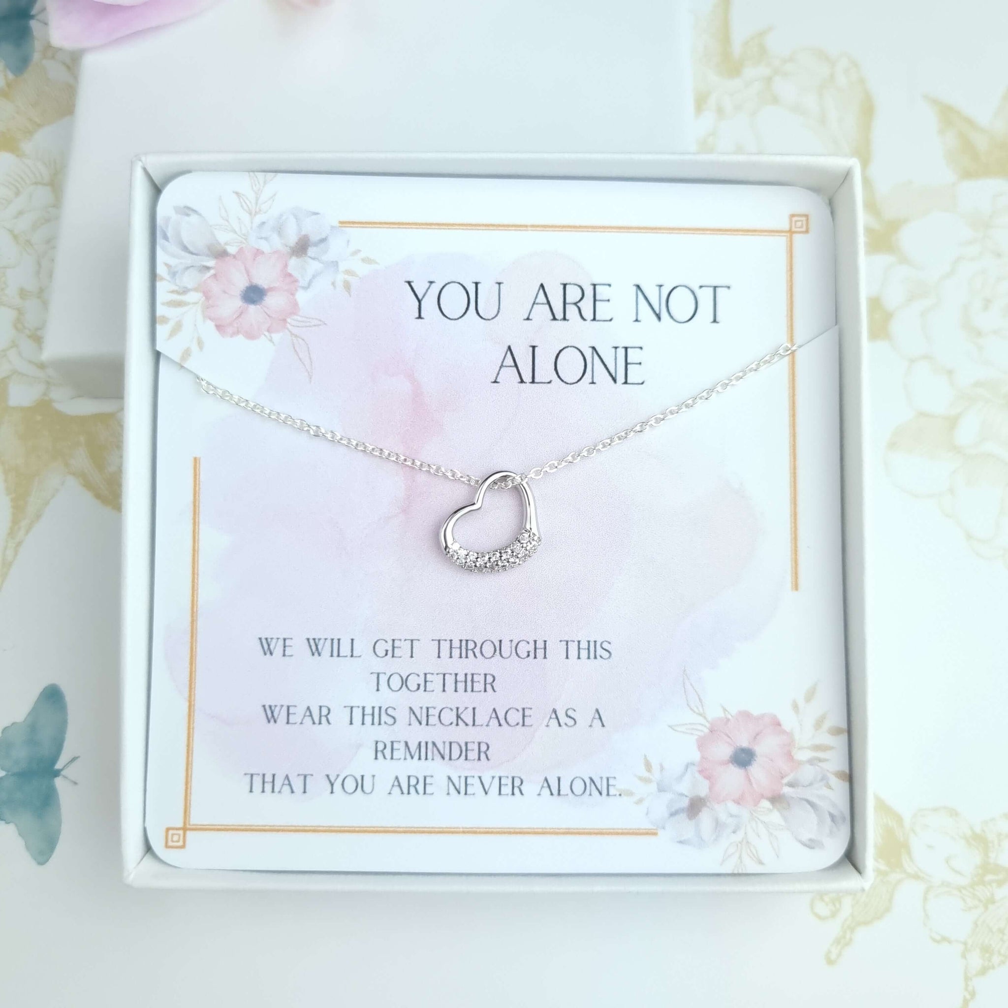 sterling silver heart necklace with a card message you are not alone inside a gift box