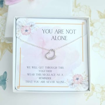 sterling silver heart necklace with a card message you are not alone inside a gift box