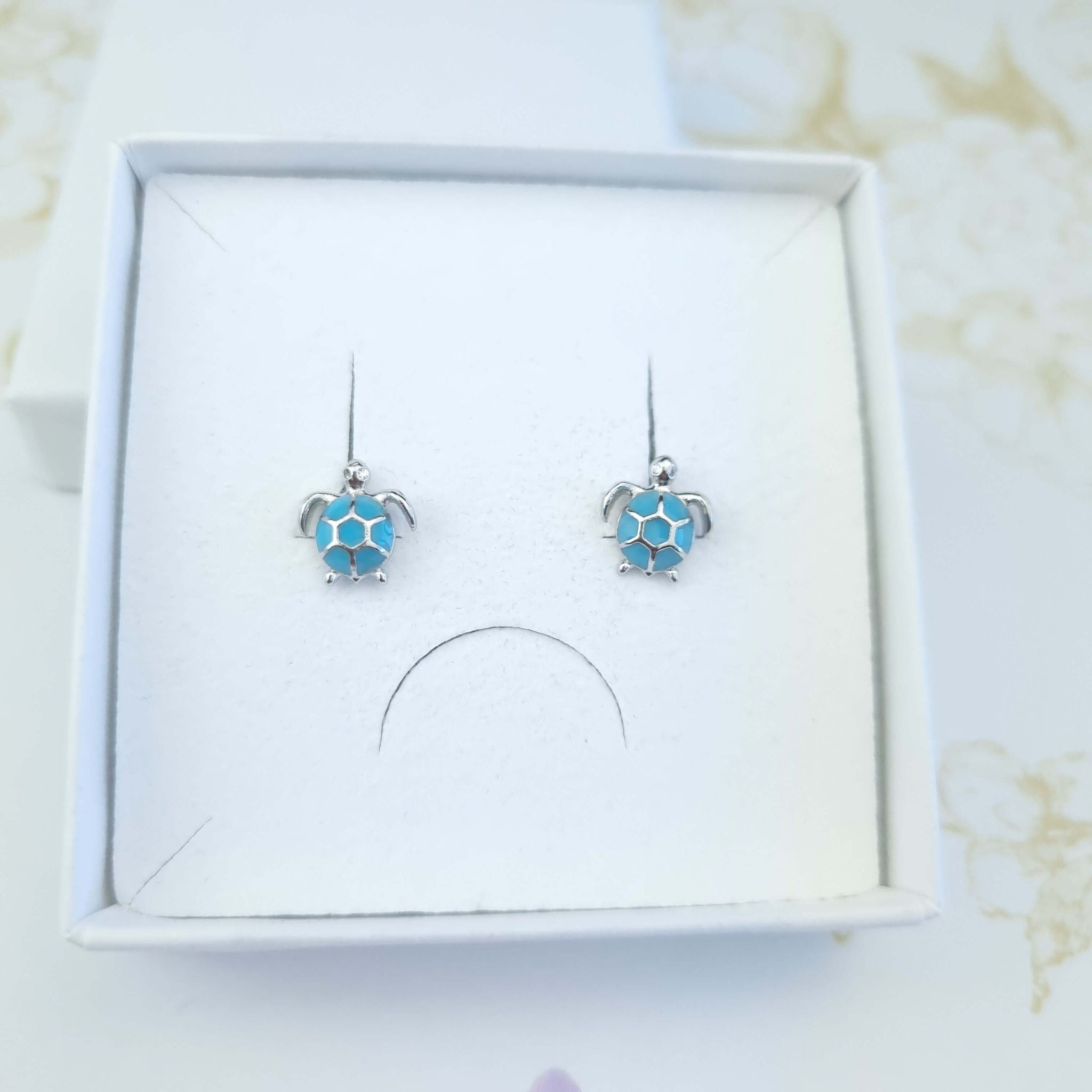 Turtle stud earrings in silver and blue