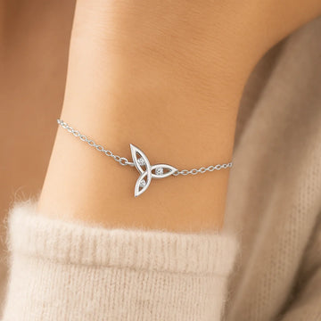a closeup wrist wearing a triquetra bracelet