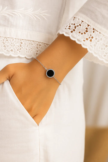 a closeup wrist showing an onix bracelet