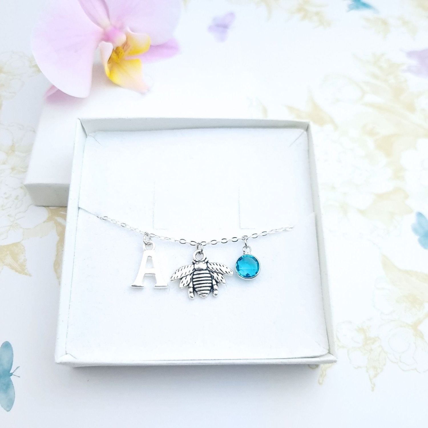 silver bracelet with bee charm in a gift box