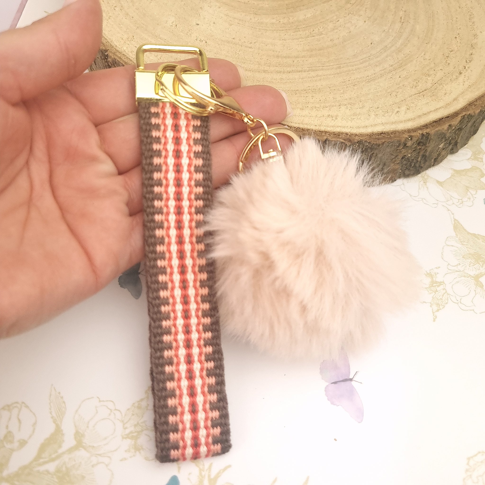 wristlet strap keychain with pom pom in terracotta tone