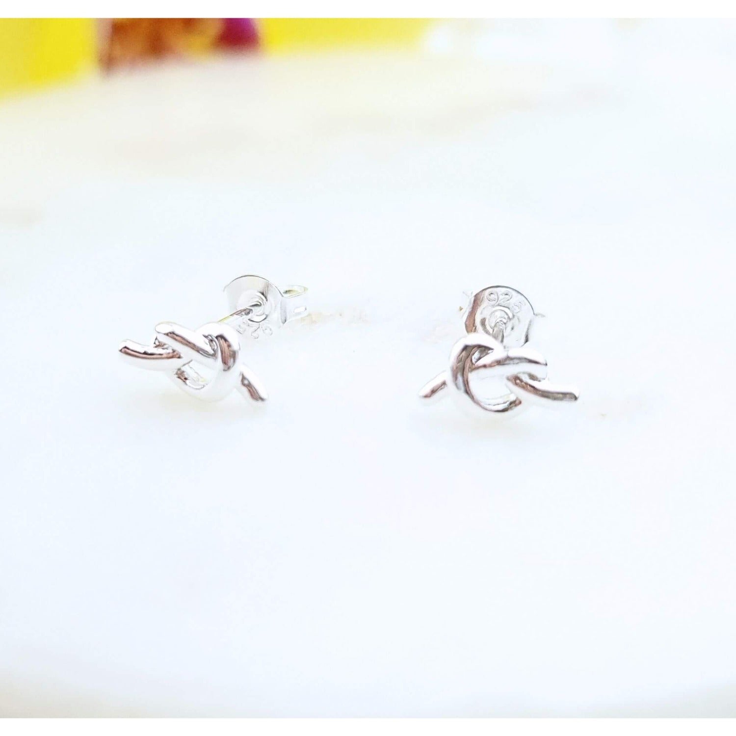 tiny knot stud earrings in sterling silver