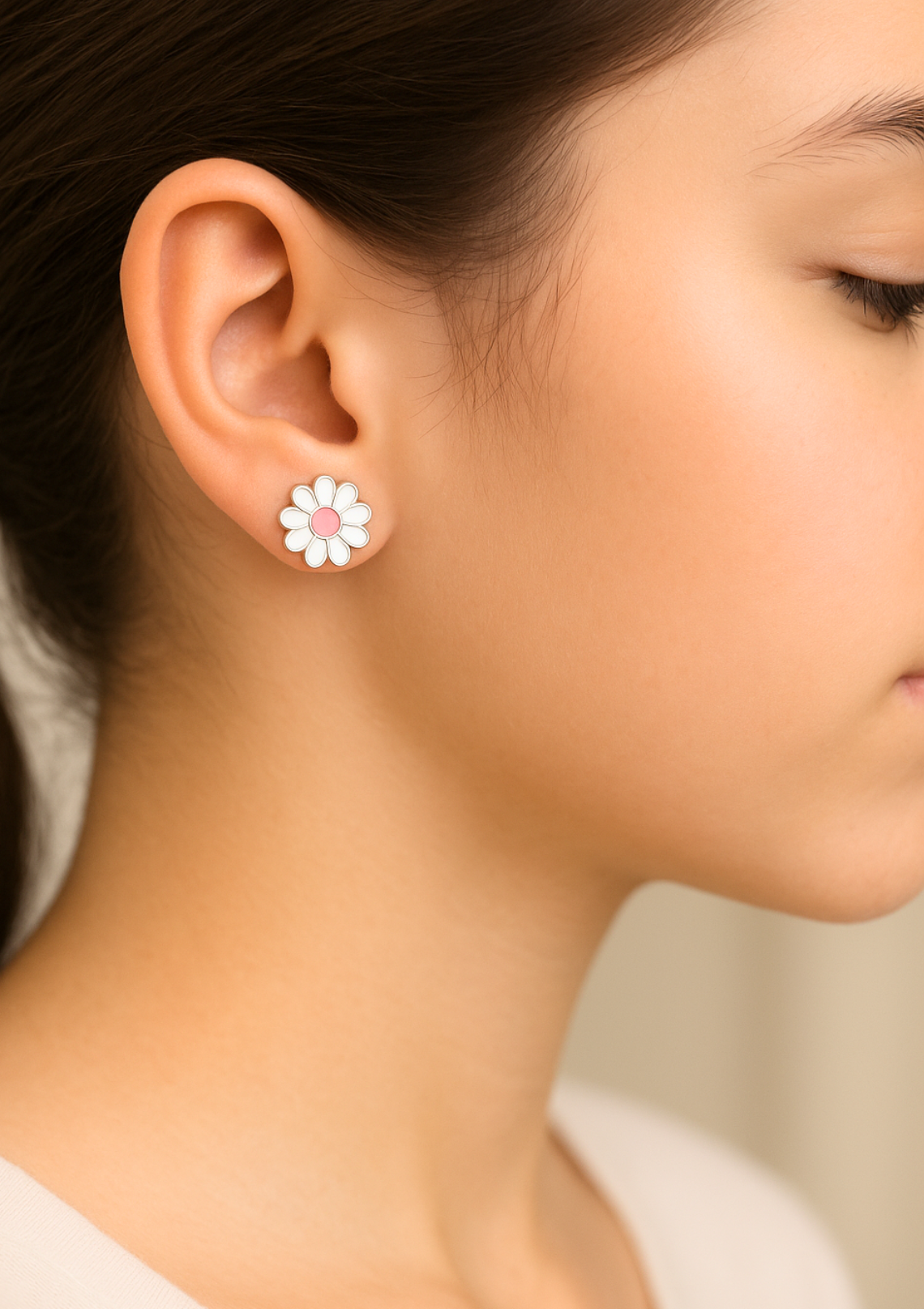 a child face wearing a sterling silver daisy earring