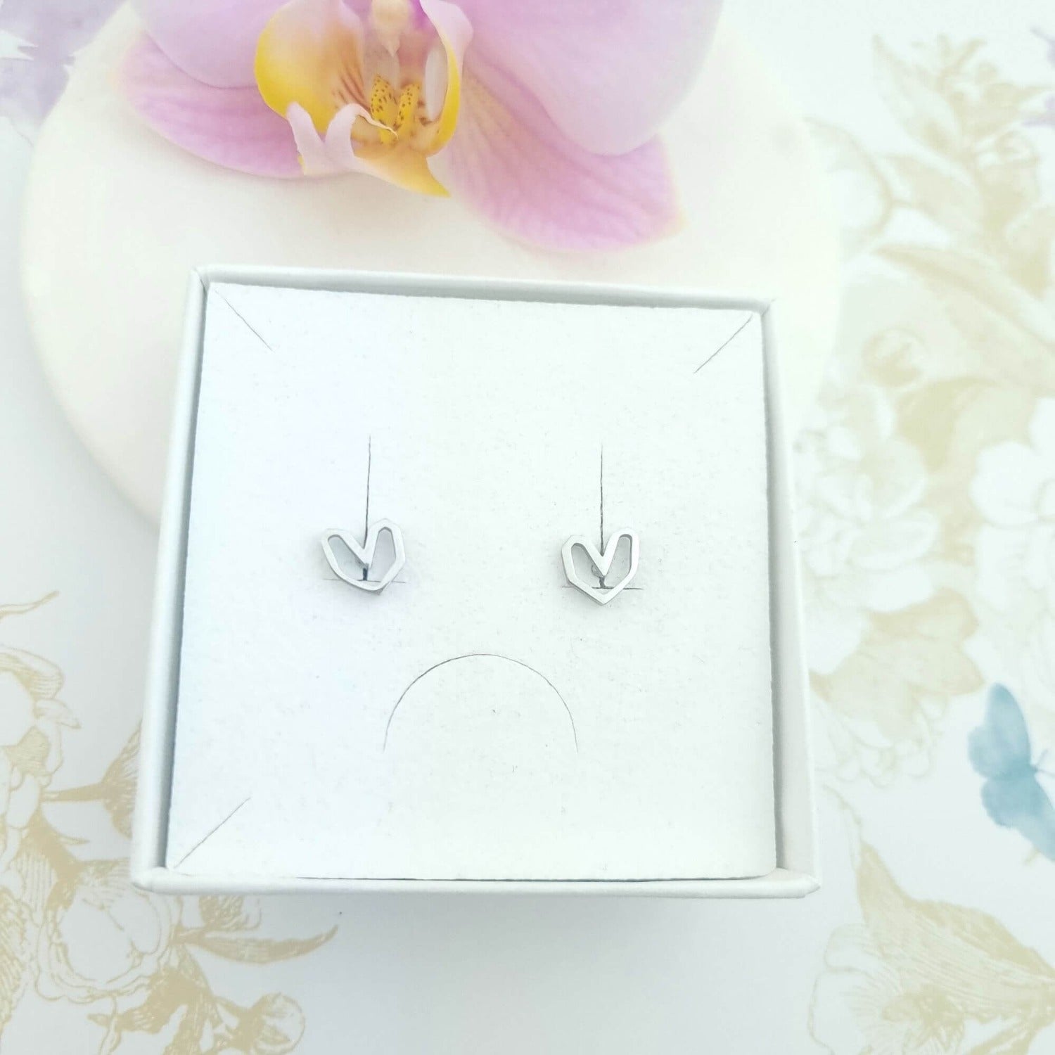 stud earrings in heart shape in a gift box