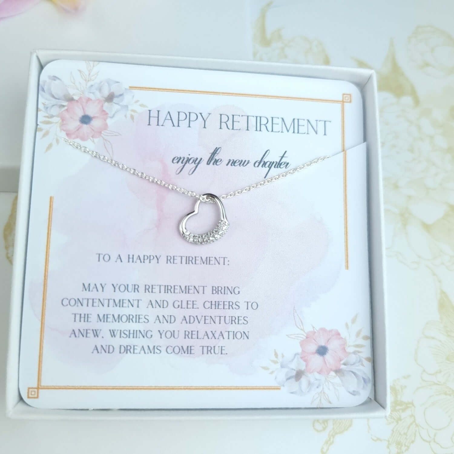 heart necklace in a gift box with a message "happy retirement"
