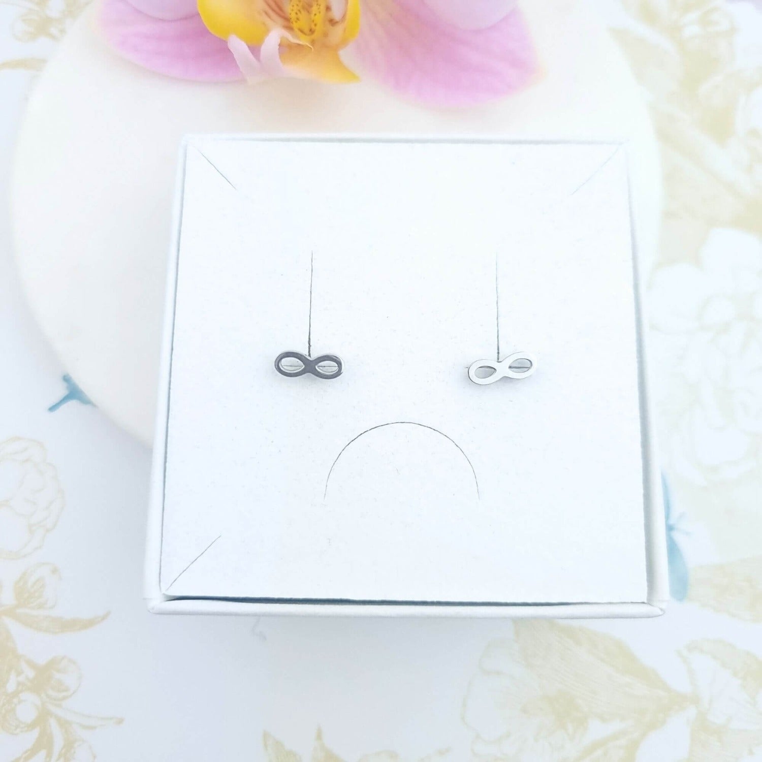 infinity stud earrings in a gift box