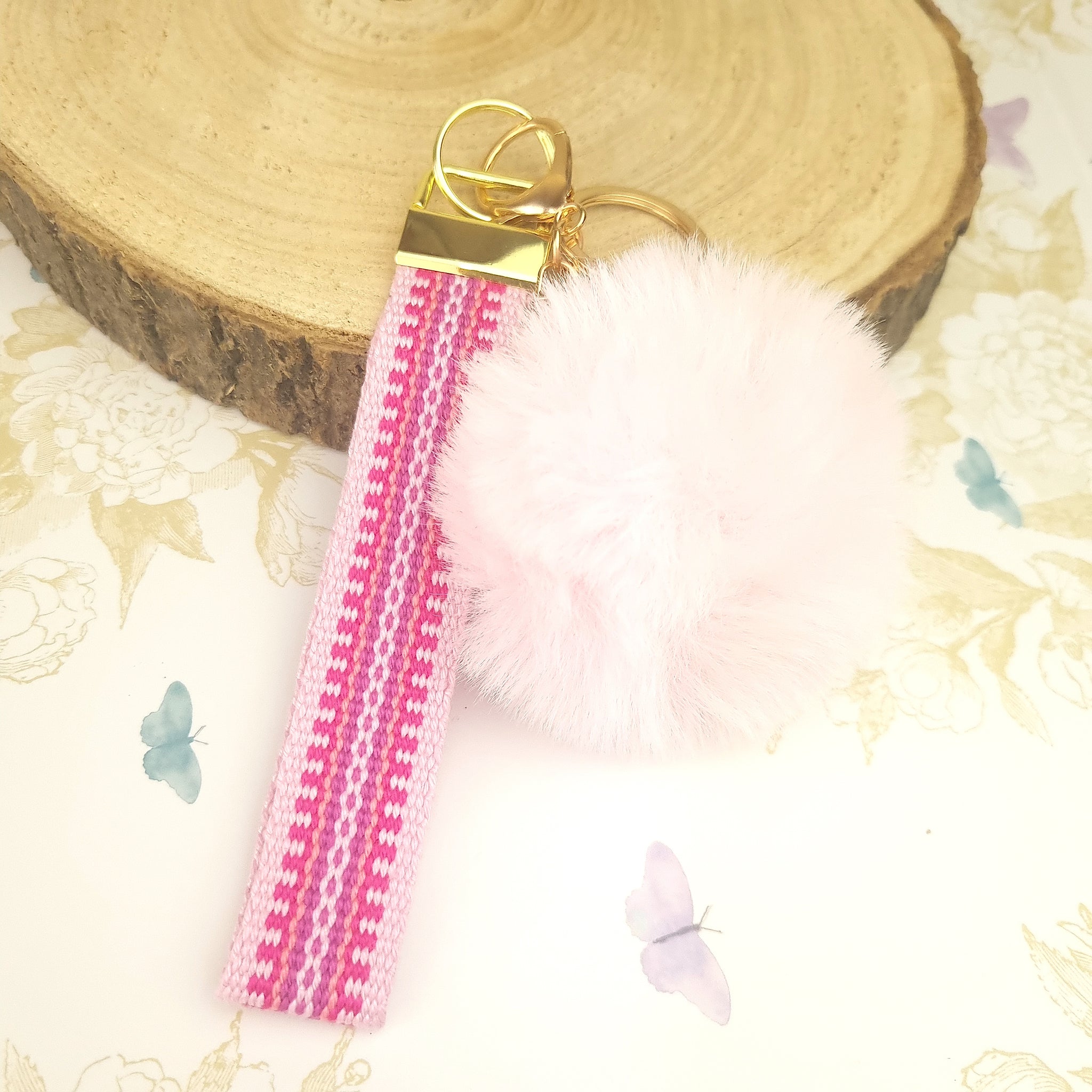 wristlet strap keychain in pink with pom pom