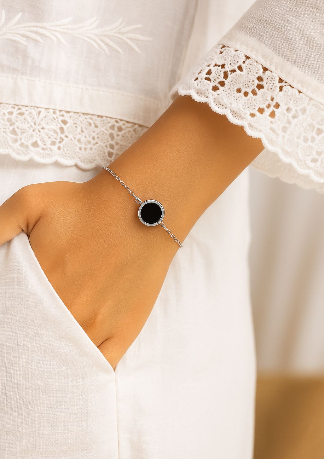 a woman wrist showing a onyx sterling silver bracelet