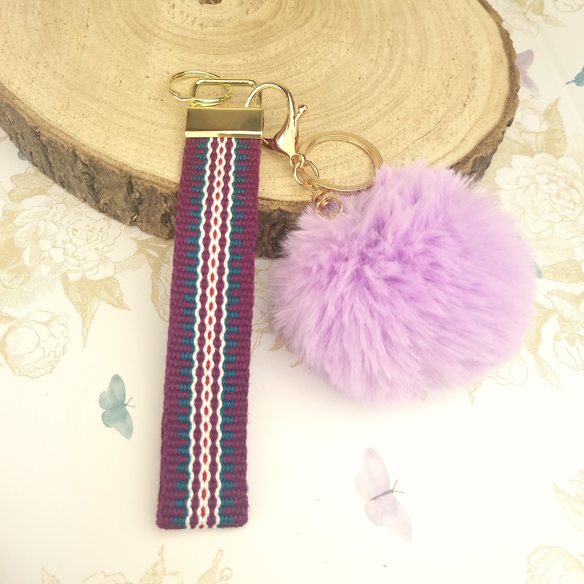 wrist lanyard in purple with pom pom