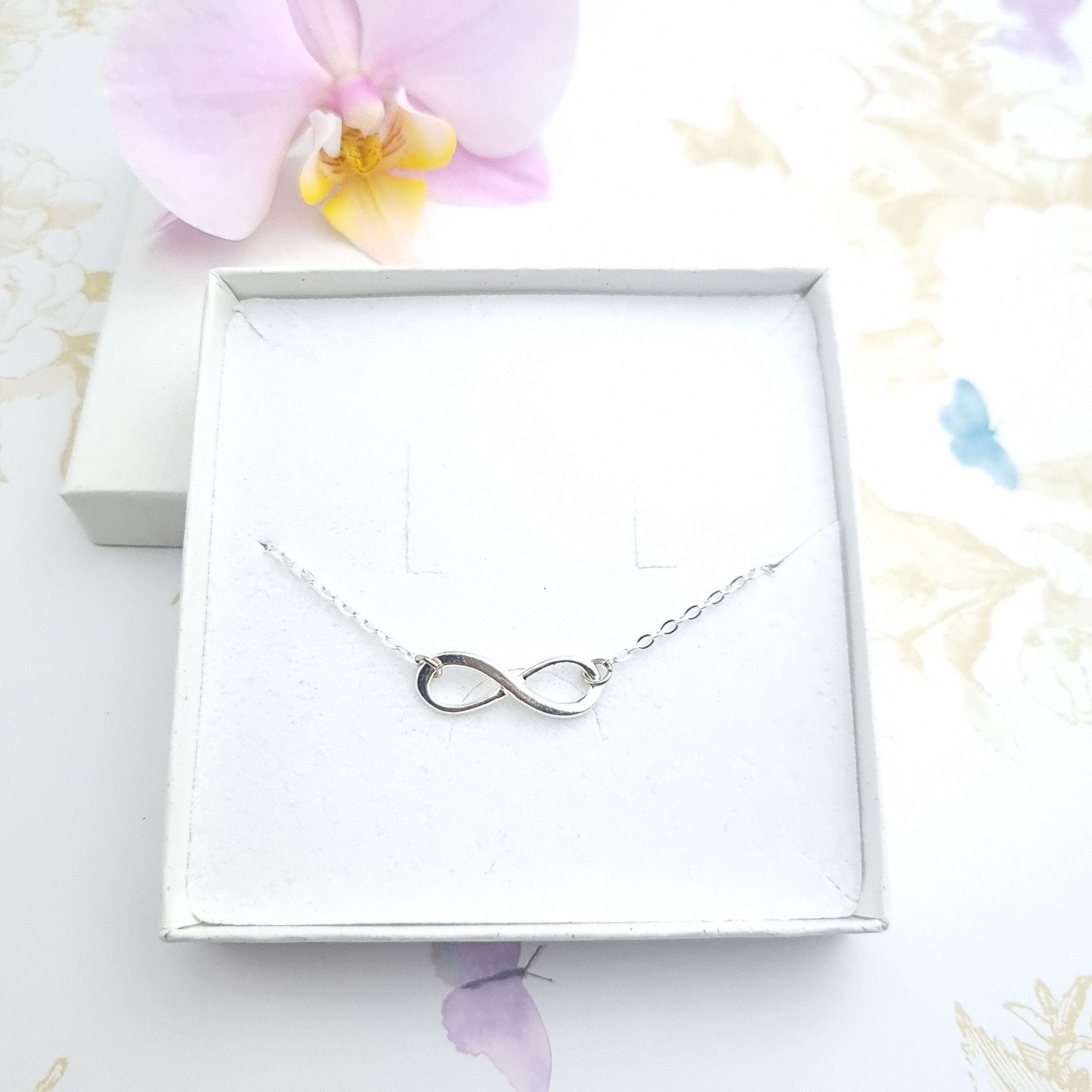 silver infinity symbol bracelet in a gift box