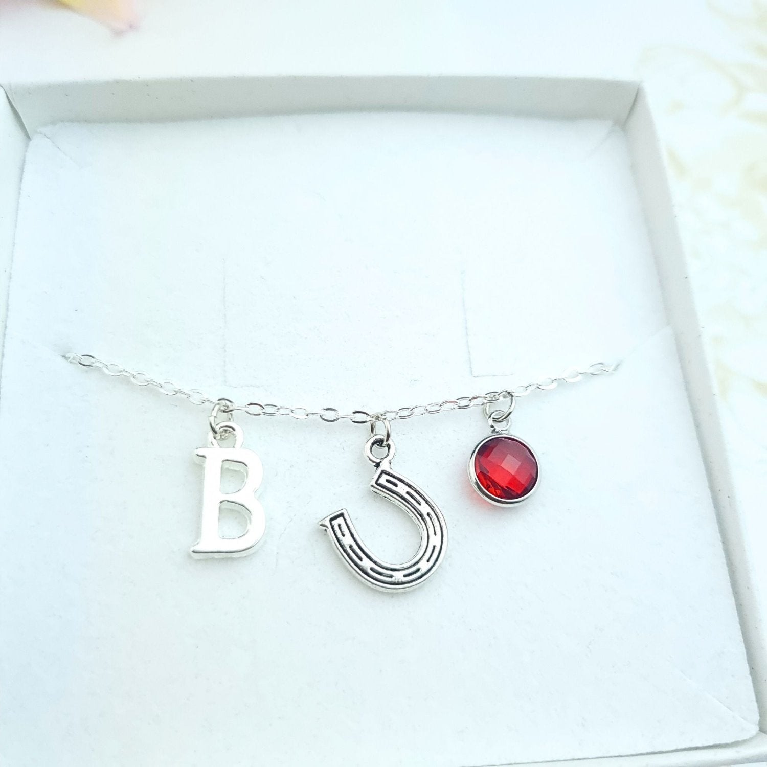 custom bracelet with horseshoe charm, initial and birthstone