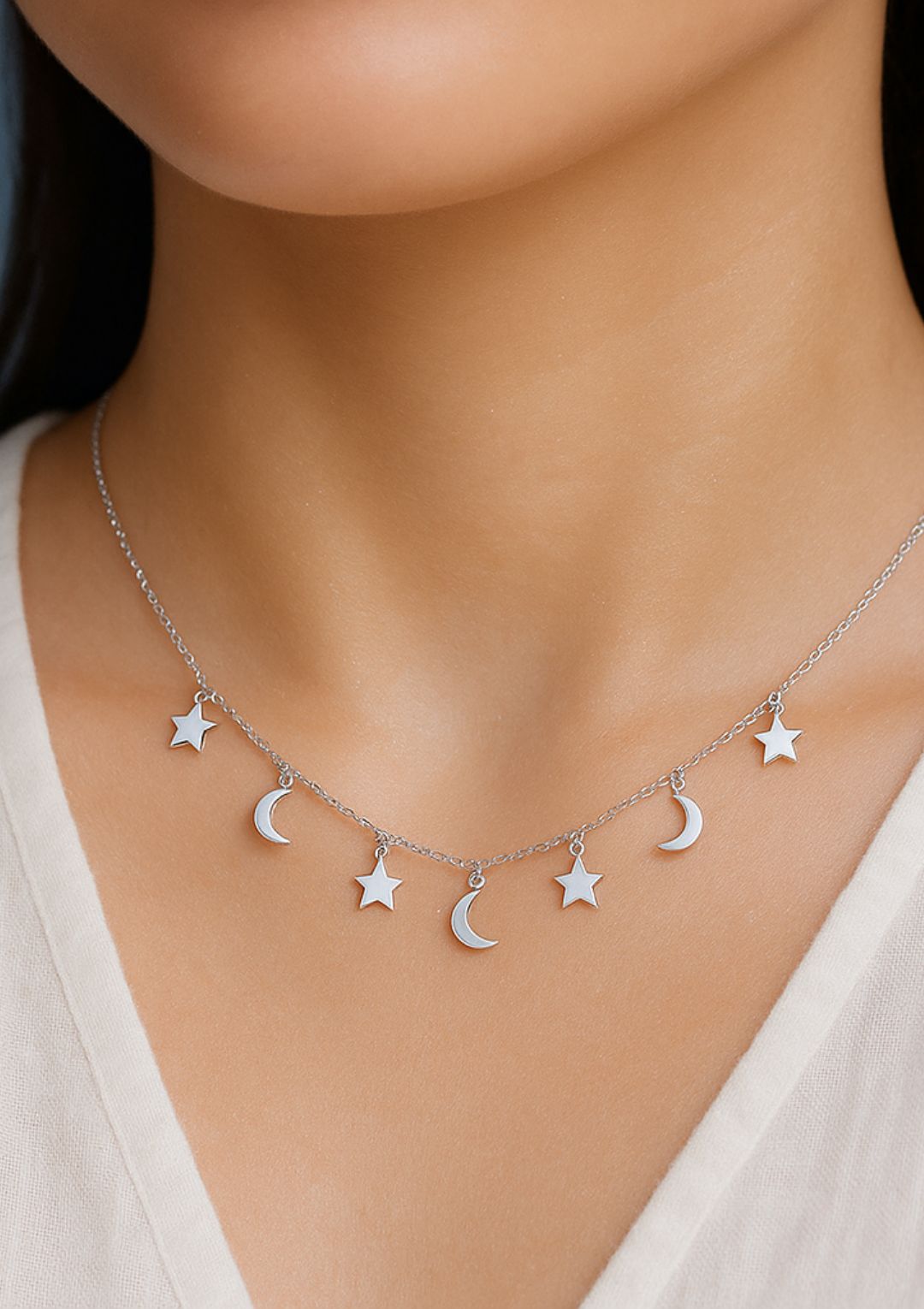 a boho style sterling silver necklace with alternate stars and moons charms