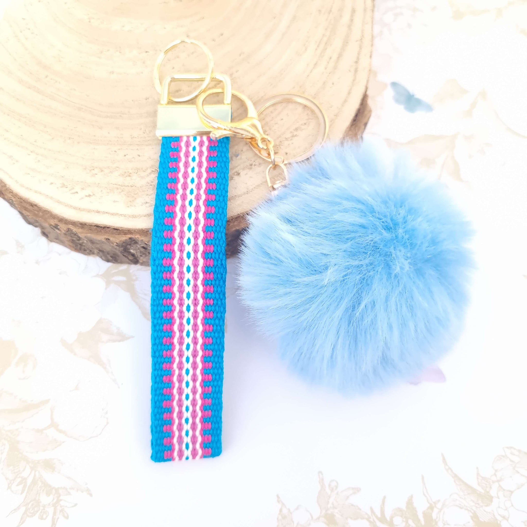 wrist lanyard in blue and pink with pompom