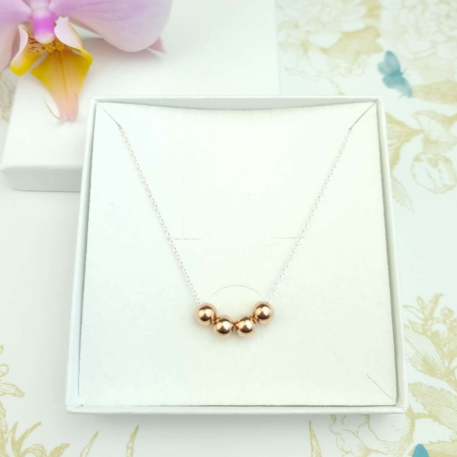 Sterling Silver necklace with four beads in rose gold