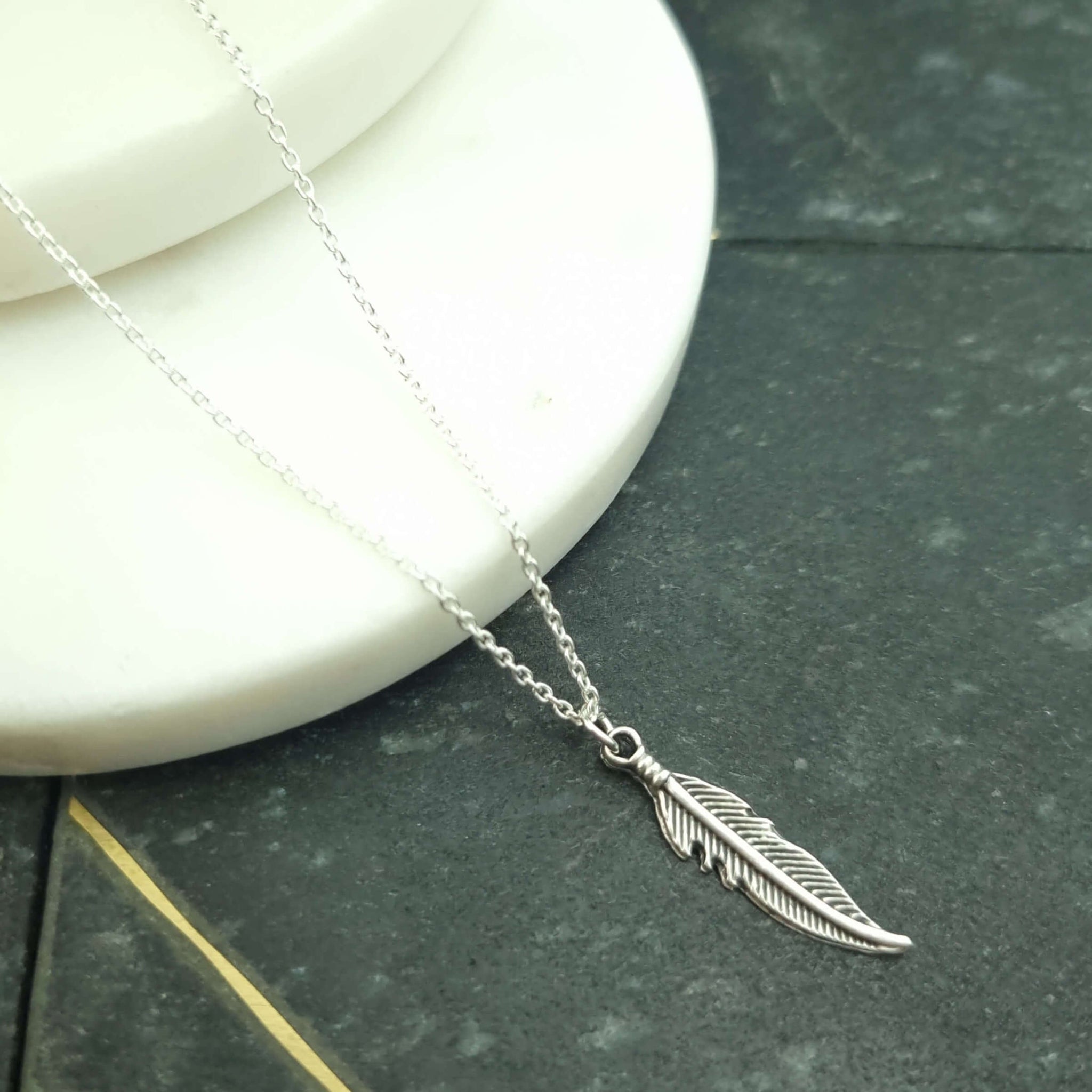 Dainty feather pendant in a sterling silver chain