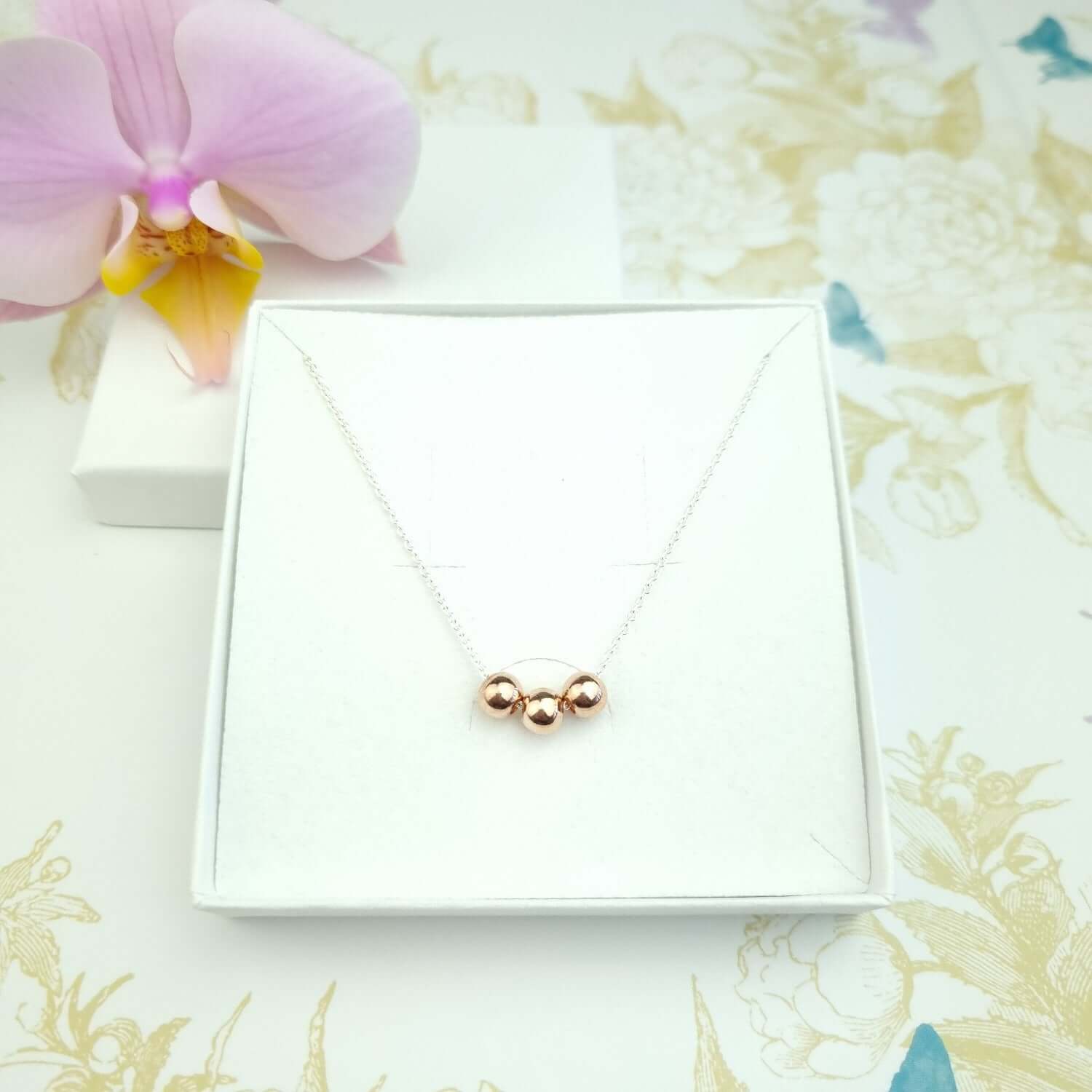Sterling silver necklace with 3 rose gold vermeil beads