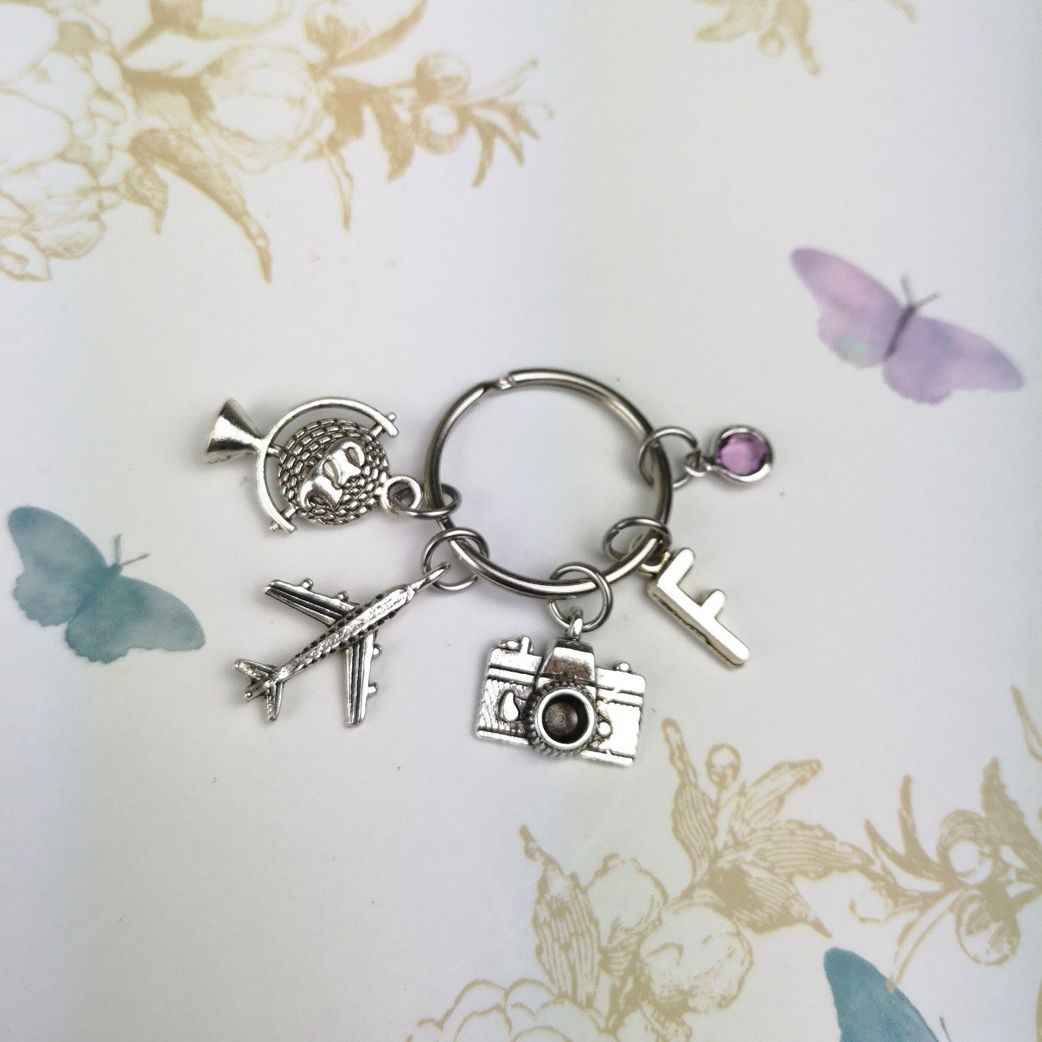 personalised keyring with camera, globe and plane charms